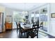 Charming dining room with dark wood floors and a view to the screened-in porch at 1918 Morning Fog Dr, Fuquay Varina, NC 27526