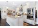 Bright kitchen with a central island, stainless steel appliances, and ample counter space at 1918 Morning Fog Dr, Fuquay Varina, NC 27526