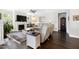 Comfortable living room featuring a fireplace, TV, hardwood floors, and light-colored reclining sofa at 1918 Morning Fog Dr, Fuquay Varina, NC 27526