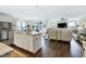 Open-concept kitchen and living room with white cabinets, island, and a fireplace focal point at 1918 Morning Fog Dr, Fuquay Varina, NC 27526