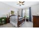 Well-lit main bedroom with four poster bed and ceiling fan at 1918 Morning Fog Dr, Fuquay Varina, NC 27526