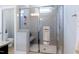 Modern tiled shower with glass door and built-in bench, enhancing bathroom functionality at 1918 Morning Fog Dr, Fuquay Varina, NC 27526