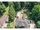 Aerial view showcasing a home with a pool, patio area, and lush, green surroundings at 2012 Silverleaf Dr, Youngsville, NC 27596