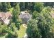 Stunning aerial view of a home nestled among lush trees, showcasing its pool and manicured lawn at 2012 Silverleaf Dr, Youngsville, NC 27596
