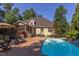 Exterior view of home featuring backyard pool, brick paver patio, screened porch, lush landscaping, and more! at 2012 Silverleaf Dr, Youngsville, NC 27596