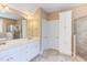 Elegant bathroom with double vanity, large mirror, walk-in shower, and soaking tub at 2012 Silverleaf Dr, Youngsville, NC 27596