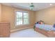 Cozy bedroom with a ceiling fan, a large window, and a charming trundle bed at 2012 Silverleaf Dr, Youngsville, NC 27596