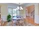 Bright dining area featuring a chandelier, large window, and wood flooring, open to the main floor at 2012 Silverleaf Dr, Youngsville, NC 27596