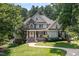 Charming two-story home with stone accents, covered porch, and beautifully landscaped front yard at 2012 Silverleaf Dr, Youngsville, NC 27596