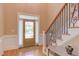 Bright foyer featuring hardwood floors, a decorative front door, and an elegant staircase at 2012 Silverleaf Dr, Youngsville, NC 27596