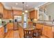 Modern kitchen with stainless appliances, island, and hardwood floors leading to a staircase at 2012 Silverleaf Dr, Youngsville, NC 27596