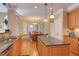 View of the kitchen and dining area, featuring granite counters and warm natural lighting at 2012 Silverleaf Dr, Youngsville, NC 27596