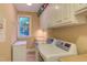 Functional laundry room equipped with washer, dryer, sink, and ample cabinet space at 2012 Silverleaf Dr, Youngsville, NC 27596