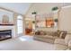 Living room with fireplace, arched windows, and views to the kitchen and dining room at 2012 Silverleaf Dr, Youngsville, NC 27596