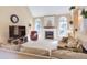 Bright living room with a vaulted ceiling, large windows, a fireplace, and comfortable furniture at 2012 Silverleaf Dr, Youngsville, NC 27596