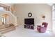 Living room featuring a staircase, large windows, and comfortable seating arrangements at 2012 Silverleaf Dr, Youngsville, NC 27596