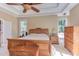 Comfortable main bedroom with wood furnishings, ceiling fan, and ample natural light at 2012 Silverleaf Dr, Youngsville, NC 27596