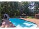 Backyard pool with slide and surrounding mature landscaping at 2012 Silverleaf Dr, Youngsville, NC 27596