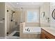 Bathroom featuring a soaking tub and separate glass shower at 204 Edgepine Dr, Holly Springs, NC 27540