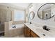 Bathroom featuring a soaking tub, double vanity, and glass enclosed shower at 204 Edgepine Dr, Holly Springs, NC 27540