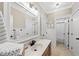 Bright bathroom featuring neutral walls, framed mirror, vanity, and beadboard accents at 204 Edgepine Dr, Holly Springs, NC 27540