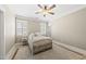 Cozy bedroom featuring a decorative metal bed frame, neutral tones, and plantation shutters at 204 Edgepine Dr, Holly Springs, NC 27540