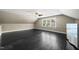 Open bonus room with dark floors, dormer window, and ceiling fan at 204 Edgepine Dr, Holly Springs, NC 27540