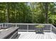 Relaxing deck space featuring outdoor dining, a privacy fence, and views of mature trees at 204 Edgepine Dr, Holly Springs, NC 27540