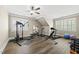 Spacious exercise room with gym equipment, ceiling fan, and natural light from the windows at 204 Edgepine Dr, Holly Springs, NC 27540