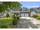 Charming two-story home with a manicured lawn, two-car garage, and inviting front porch at 204 Edgepine Dr, Holly Springs, NC 27540