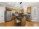 Well-equipped kitchen with stainless steel appliances, a granite countertop island, and ample storage at 204 Edgepine Dr, Holly Springs, NC 27540