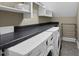 Functional laundry room equipped with modern washer and dryer and ample counter space at 204 Edgepine Dr, Holly Springs, NC 27540