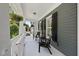 Inviting front porch with seating, offering a relaxing outdoor space with black shutters at 204 Edgepine Dr, Holly Springs, NC 27540