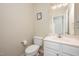 Standard bathroom with a toilet, sink, and mirror over the vanity at 25 Silver Pl # Apt B, Angier, NC 27501