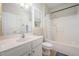 Bathroom with tub-shower combo and white vanity with matching medicine cabinet mirror at 25 Silver Pl # Apt B, Angier, NC 27501