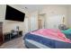 Bedroom showing a bed, TV, storage console, and window with natural light at 25 Silver Pl # Apt B, Angier, NC 27501
