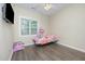 Bedroom with hardwood flooring, ceiling fan, and a window with natural light at 25 Silver Pl # Apt B, Angier, NC 27501