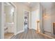 Hallway with hardwood flooring and doorways to the bathroom and bedrooms at 25 Silver Pl # Apt B, Angier, NC 27501