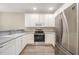 Modern kitchen features white cabinetry, updated stainless steel appliances, and functional design at 25 Silver Pl # Apt B, Angier, NC 27501