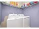 Laundry room featuring a white washer and dryer, with storage shelves above at 25 Silver Pl # Apt B, Angier, NC 27501