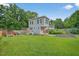 Large backyard with lush green grass, garden, and an outbuilding at 2503 Shirley St, Durham, NC 27705