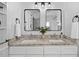 Bathroom with double sinks, modern mirrors, granite countertops, and white cabinets at 2503 Shirley St, Durham, NC 27705