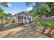 Exterior view of this home showing the driveway, beautiful landscaping, and cozy front porch at 2503 Shirley St, Durham, NC 27705