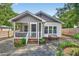 Charming home with a screened front porch, beautiful stone path and cozy seating at 2503 Shirley St, Durham, NC 27705