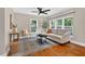 Inviting living room featuring hardwood floors, a ceiling fan, and bright windows at 2503 Shirley St, Durham, NC 27705