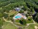 Aerial view of community amenities including a swimming pool, clubhouse, and tennis courts at 2602 Vintage Hill Ct, Durham, NC 27712
