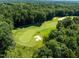 Aerial view of manicured green golf course with sand traps and lush surroundings at 2602 Vintage Hill Ct, Durham, NC 27712
