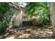 View of the backyard featuring a trampoline and multi-level deck surrounded by lush landscaping at 2602 Vintage Hill Ct, Durham, NC 27712
