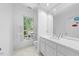 Bathroom features white cabinets, a large mirror, and a window for natural light at 2602 Vintage Hill Ct, Durham, NC 27712