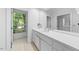 Bathroom featuring a long vanity with sink and large window offering outdoor views at 2602 Vintage Hill Ct, Durham, NC 27712